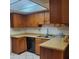 Well-maintained kitchen with oak cabinets, laminate countertops, and modern dishwasher at 13041 N 51St Dr, Glendale, AZ 85304