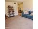 Inviting living room with comfortable seating, a bookshelf and neutral decor at 13041 N 51St Dr, Glendale, AZ 85304