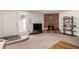 Inviting living room with a brick fireplace, neutral carpet, and plenty of natural light at 13041 N 51St Dr, Glendale, AZ 85304
