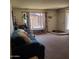 Inviting living room featuring a comfortable blue couch and bright natural light at 13041 N 51St Dr, Glendale, AZ 85304