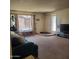 Cozy living room with a large window and door, filling the space with natural light at 13041 N 51St Dr, Glendale, AZ 85304