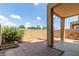 Cozy backyard with a covered patio, brick pavers and a privacy wall, creating a private outdoor living space at 1350 S Greenfield Rd # 1005, Mesa, AZ 85206