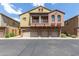 Three-story townhome features stucco, garages, stone accents, and a charming balcony at 1350 S Greenfield Rd # 1005, Mesa, AZ 85206