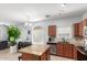 Well-lit kitchen with island, tiled floor, stainless steel appliances, and access to the living room at 1350 S Greenfield Rd # 1005, Mesa, AZ 85206
