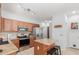 Updated kitchen features stainless appliances, granite counters, and a cozy center island with bar stools at 1350 S Greenfield Rd # 1005, Mesa, AZ 85206