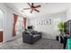 Bright living room with gray carpet, neutral walls, ceiling fan, and a large window at 1350 S Greenfield Rd # 1005, Mesa, AZ 85206