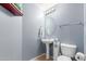 This lovely powder room includes a pedestal sink, neutral colors, and updated fixtures at 1350 S Greenfield Rd # 1005, Mesa, AZ 85206