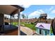 Spacious backyard with lush artificial turf, playground, hot tub, and covered patio at 14952 W Maui Ln, Surprise, AZ 85379
