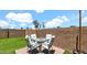 Enjoy outdoor dining on the patio with comfortable seating and serene views of the landscaped backyard at 14952 W Maui Ln, Surprise, AZ 85379