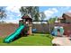 Lush backyard play area features a playset, swings, and green artificial turf for year-round fun at 14952 W Maui Ln, Surprise, AZ 85379