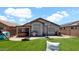 Large backyard featuring a covered patio, hot tub, grill, and basketball hoop, ideal for outdoor living at 14952 W Maui Ln, Surprise, AZ 85379
