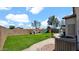 Expansive backyard with play area, outdoor seating, lush artificial turf and privacy wall at 14952 W Maui Ln, Surprise, AZ 85379