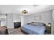 Well-lit bedroom featuring a queen bed, dark furniture, updated lighting, and neutral-toned decor at 14952 W Maui Ln, Surprise, AZ 85379