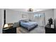 Comfortable bedroom with stylish rug, soft lighting, and soothing blue accents for a relaxing retreat at 14952 W Maui Ln, Surprise, AZ 85379