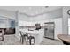 Modern kitchen featuring white cabinetry, stainless steel appliances and a breakfast bar at 14952 W Maui Ln, Surprise, AZ 85379