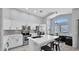 Bright, open-concept kitchen with white cabinets, stainless steel appliances, and a breakfast nook at 14952 W Maui Ln, Surprise, AZ 85379
