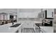 Modern kitchen featuring white cabinets, stainless steel appliances and patterned backsplash at 14952 W Maui Ln, Surprise, AZ 85379