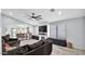 Spacious living room features a modern ceiling fan, shiplap fireplace, and large windows for natural light at 14952 W Maui Ln, Surprise, AZ 85379