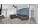 Cozy living room featuring a sectional sofa, ceiling fan and accent wall at 14952 W Maui Ln, Surprise, AZ 85379