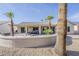 Rear exterior view featuring a patio area with outdoor seating and lush landscaping at 15411 W Amelia Dr, Goodyear, AZ 85395
