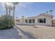 Exterior view of the home and patio area surrounded by desert landscaping at 15411 W Amelia Dr, Goodyear, AZ 85395