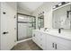 Bathroom featuring double sink, new fixtures, and glass-enclosed shower at 15411 W Amelia Dr, Goodyear, AZ 85395