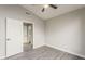 Bedroom featuring light gray walls, wood floors, and a door leading to an en-suite bathroom at 15411 W Amelia Dr, Goodyear, AZ 85395