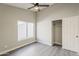 Bright bedroom with window, ceiling fan, and a closet with sliding doors at 15411 W Amelia Dr, Goodyear, AZ 85395