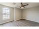 Bedroom with a large window, ceiling fan, and light gray walls at 15411 W Amelia Dr, Goodyear, AZ 85395