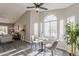 Charming dining nook with a large window, vaulted ceiling, and views into the adjacent living space at 15411 W Amelia Dr, Goodyear, AZ 85395