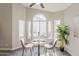 Inviting dining space with a marble table, comfortable seating, and natural light from the large windows at 15411 W Amelia Dr, Goodyear, AZ 85395