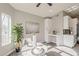 Bright dining area with a marble table, modern decor, and sunlight streaming through a large window at 15411 W Amelia Dr, Goodyear, AZ 85395