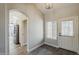Inviting entryway featuring wood-look floors, leading to a bright kitchen with stainless appliances at 15411 W Amelia Dr, Goodyear, AZ 85395