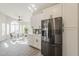 Bright kitchen featuring white cabinets and modern stainless steel refrigerator at 15411 W Amelia Dr, Goodyear, AZ 85395