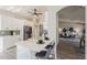 Bright kitchen boasts white cabinets, breakfast bar, modern appliances, and easy access to the inviting living room at 15411 W Amelia Dr, Goodyear, AZ 85395