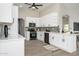 Modern kitchen with white cabinets, stainless steel appliances, and gray backsplash at 15411 W Amelia Dr, Goodyear, AZ 85395