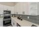 Close-up of kitchen with stainless steel oven and white countertops at 15411 W Amelia Dr, Goodyear, AZ 85395