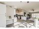 Open-concept kitchen featuring white cabinetry, stainless steel appliances, and an integrated dining area at 15411 W Amelia Dr, Goodyear, AZ 85395