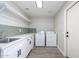 Laundry room featuring washing machine, dryer, sink, counter space, and overhead storage at 15411 W Amelia Dr, Goodyear, AZ 85395