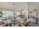 Spacious living area with dining space, featuring wood-look floors and bright, neutral walls at 15411 W Amelia Dr, Goodyear, AZ 85395