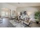 Bright living room with modern decor, archway details, and stylish wood-look flooring at 15411 W Amelia Dr, Goodyear, AZ 85395