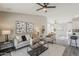 Open-plan living room with comfortable seating, stylish decor, and easy access to the dining area and kitchen at 15411 W Amelia Dr, Goodyear, AZ 85395