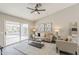 Bright living room with a cozy sofa, stylish decor, and a sliding glass door providing outdoor access at 15411 W Amelia Dr, Goodyear, AZ 85395