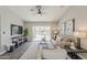 Bright living room with comfortable seating, stylish decor, and access to the outdoor patio through sliding glass doors at 15411 W Amelia Dr, Goodyear, AZ 85395