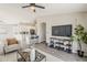 Spacious living room showcasing an open layout to the kitchen, bar seating, and modern furnishings at 15411 W Amelia Dr, Goodyear, AZ 85395