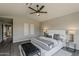 Spacious and inviting main bedroom features modern décor, a ceiling fan, and a view to the entryway from the bedroom at 15411 W Amelia Dr, Goodyear, AZ 85395