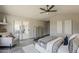 Open and airy main bedroom offers great light, sliding doors to the back yard, sitting area, and vaulted ceilings at 15411 W Amelia Dr, Goodyear, AZ 85395