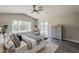 Main bedroom features a ceiling fan, slider to the back yard, a sitting area, and exterior view of the property at 15411 W Amelia Dr, Goodyear, AZ 85395