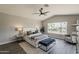 Spacious main bedroom offers a ceiling fan, sitting area, vaulted ceilings, and an abundance of natural light at 15411 W Amelia Dr, Goodyear, AZ 85395
