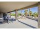 Covered patio with outdoor seating area and decorative rock landscaping at 15411 W Amelia Dr, Goodyear, AZ 85395